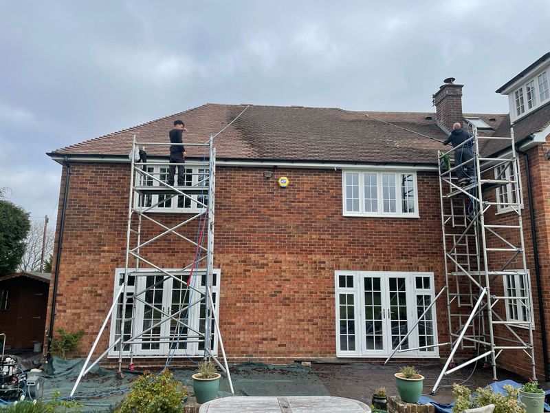 Roof cleaning carried out safely from scaffold towers by The Roof Moss Cleaners in Steyning